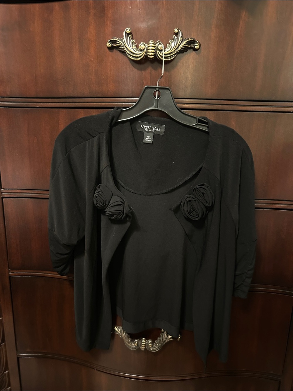 Women's black layered top with floral accents